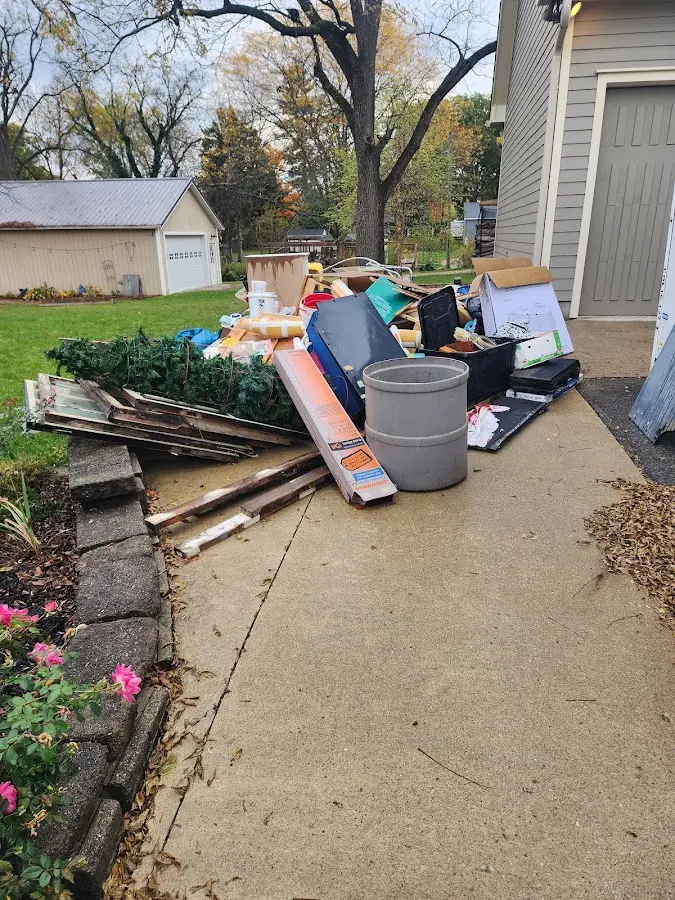Dumpster being loaded with debris for Commercial Dumpster Rental in Edgewater